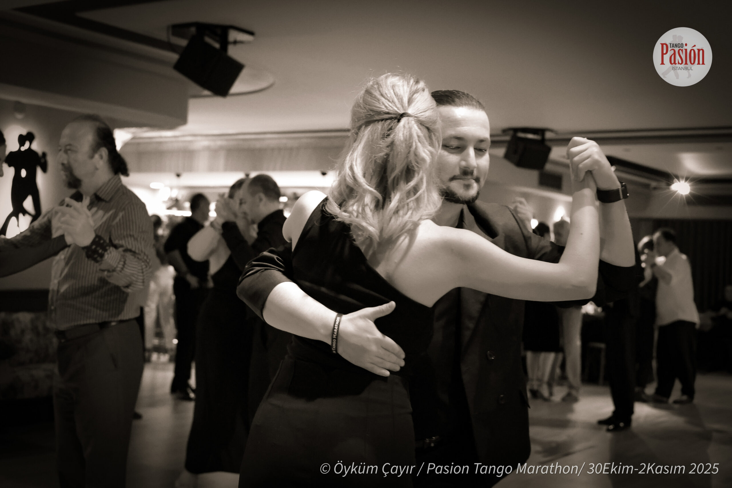 Black and white photo of dancers in close embrace